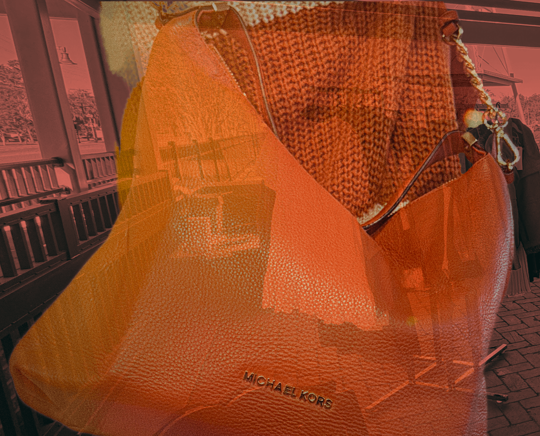 women inside a vintage market, carrying a orange  restored pre-loved "Michael Kors" bag on her shoulder. 