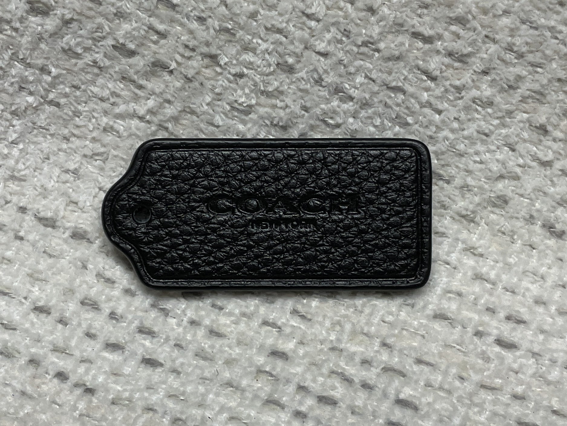 pre-owned authentic coach leather hang tag textured front view