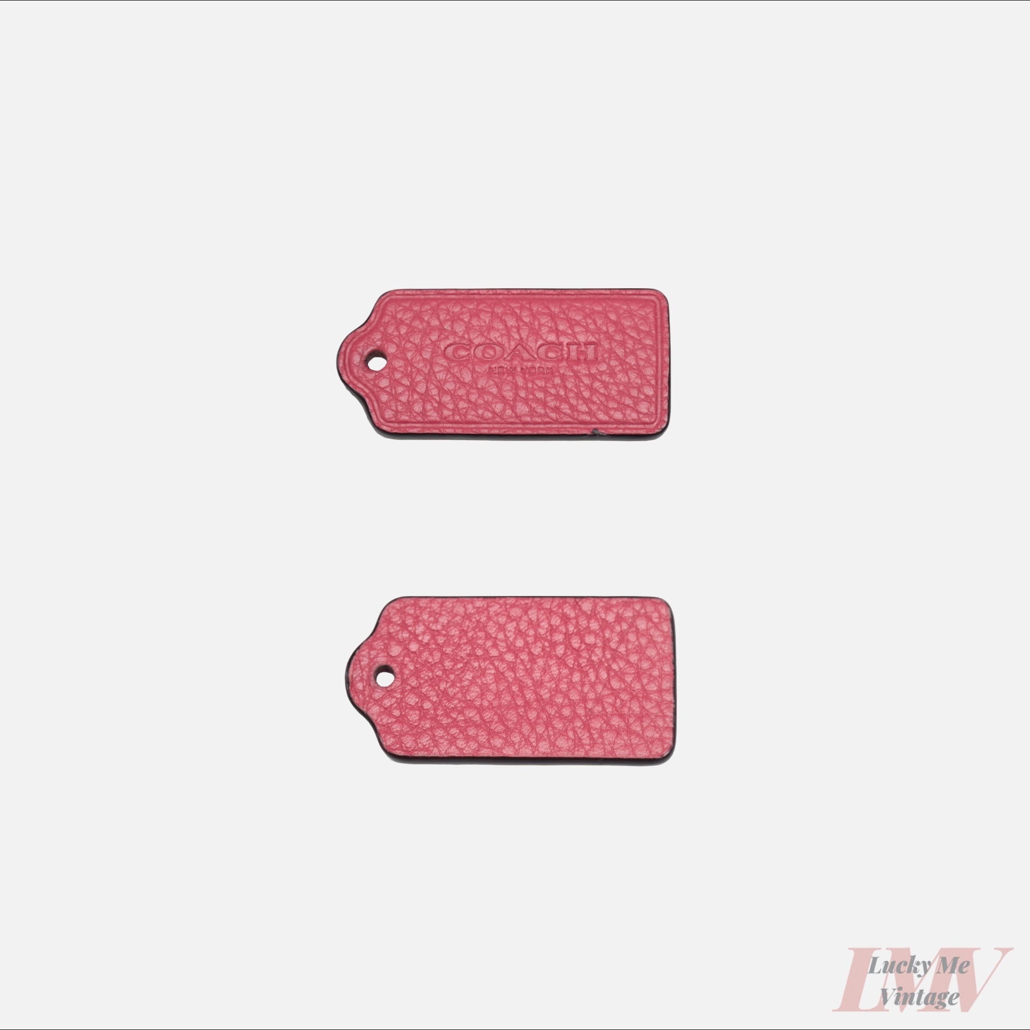 Two 2.5 inch dark pink color leather tags showing front and back with 'Coach' branding on a white background. 