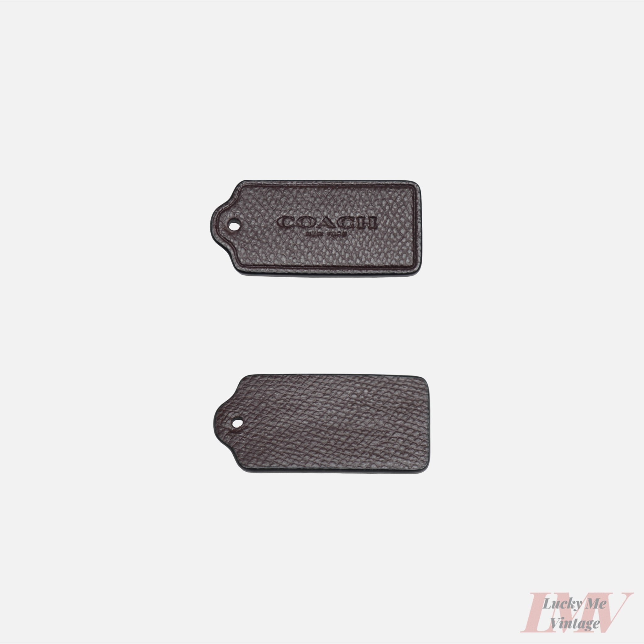 Two 2.5 inch meriot color leather tags showing front and back with 'Coach' branding on a white background. 