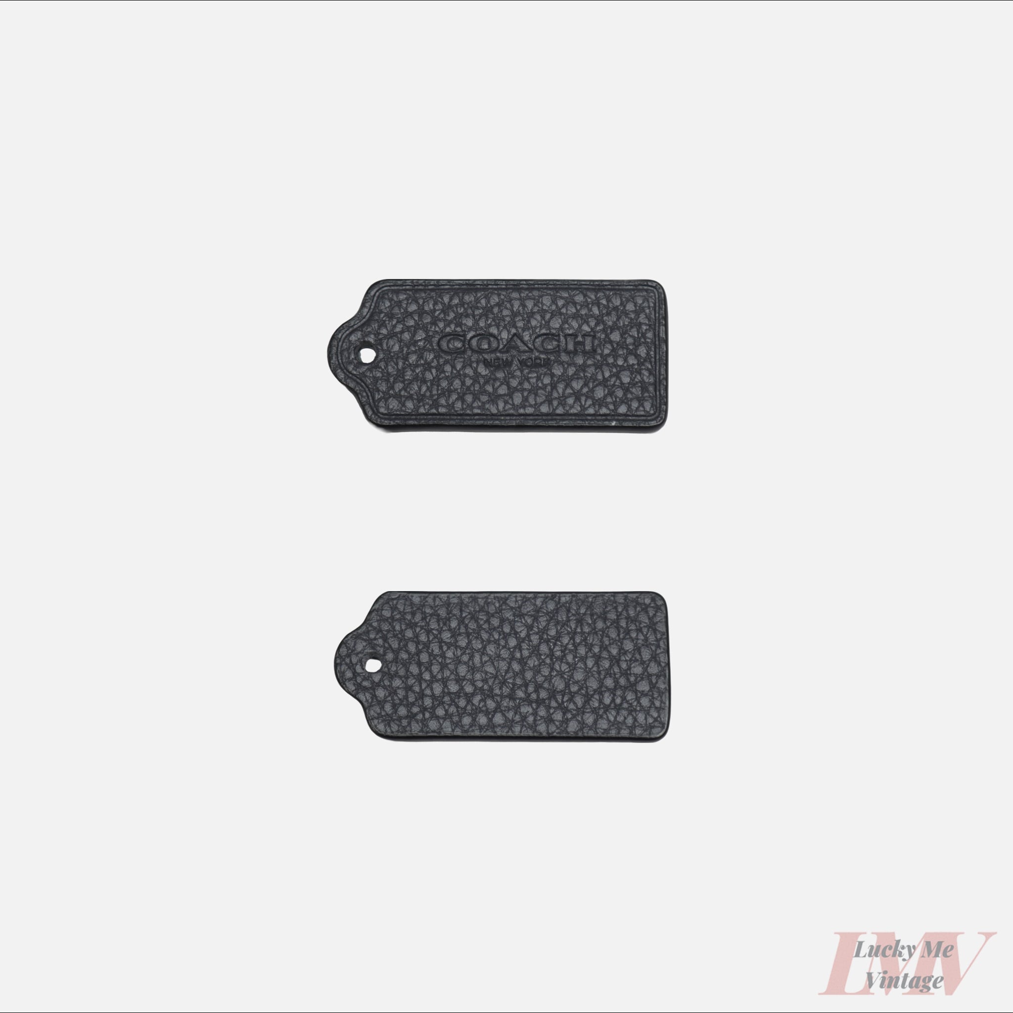 Two 2.5 inch navy color leather tags showing front and back with 'Coach' branding on a white background. 