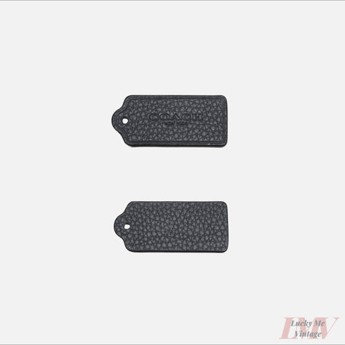 Two 2.5 inch navy color leather tags showing front and back with 'Coach' branding on a white background. 