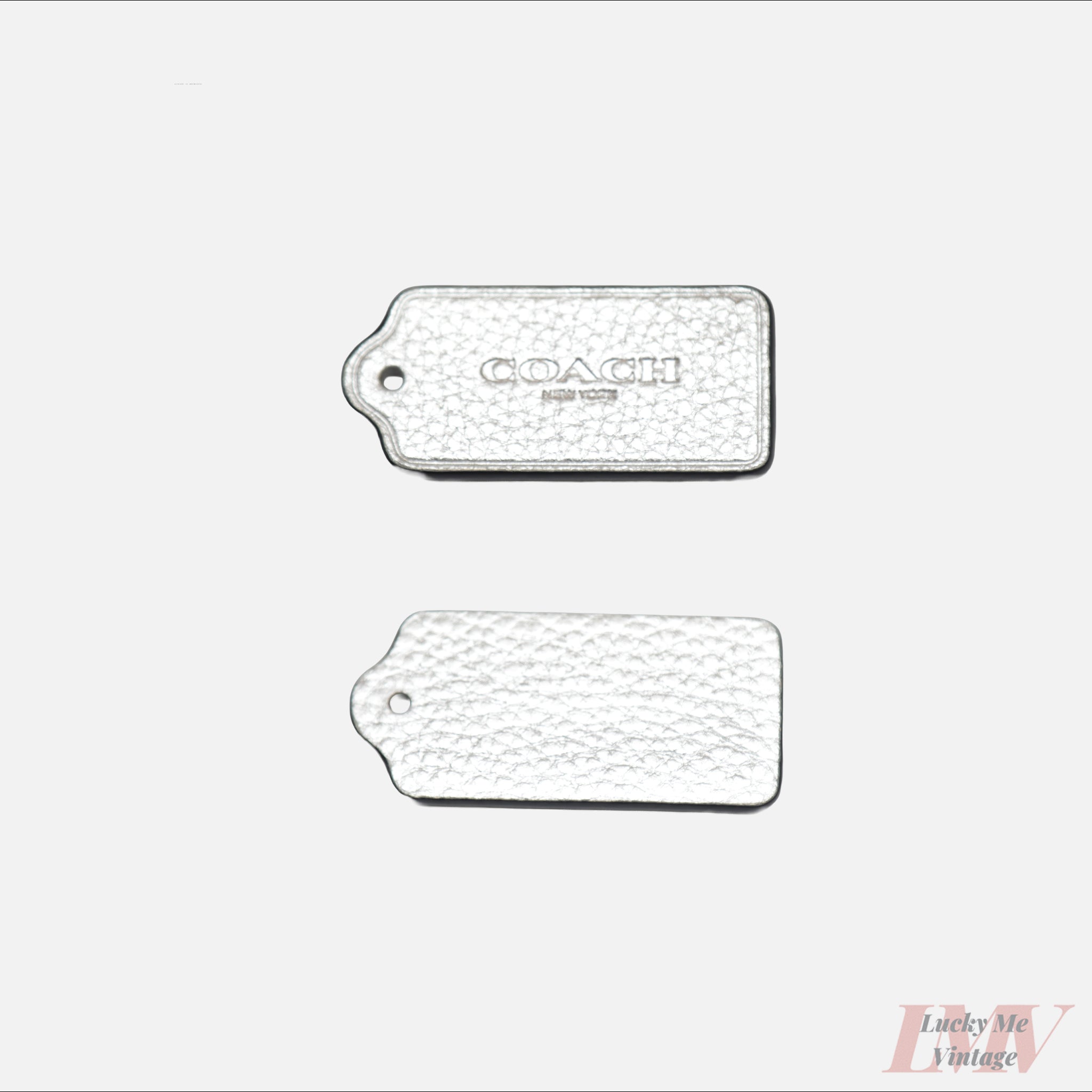 2.5 inch silver color leather tags showing front and back with 'Coach' branding on a white background. 